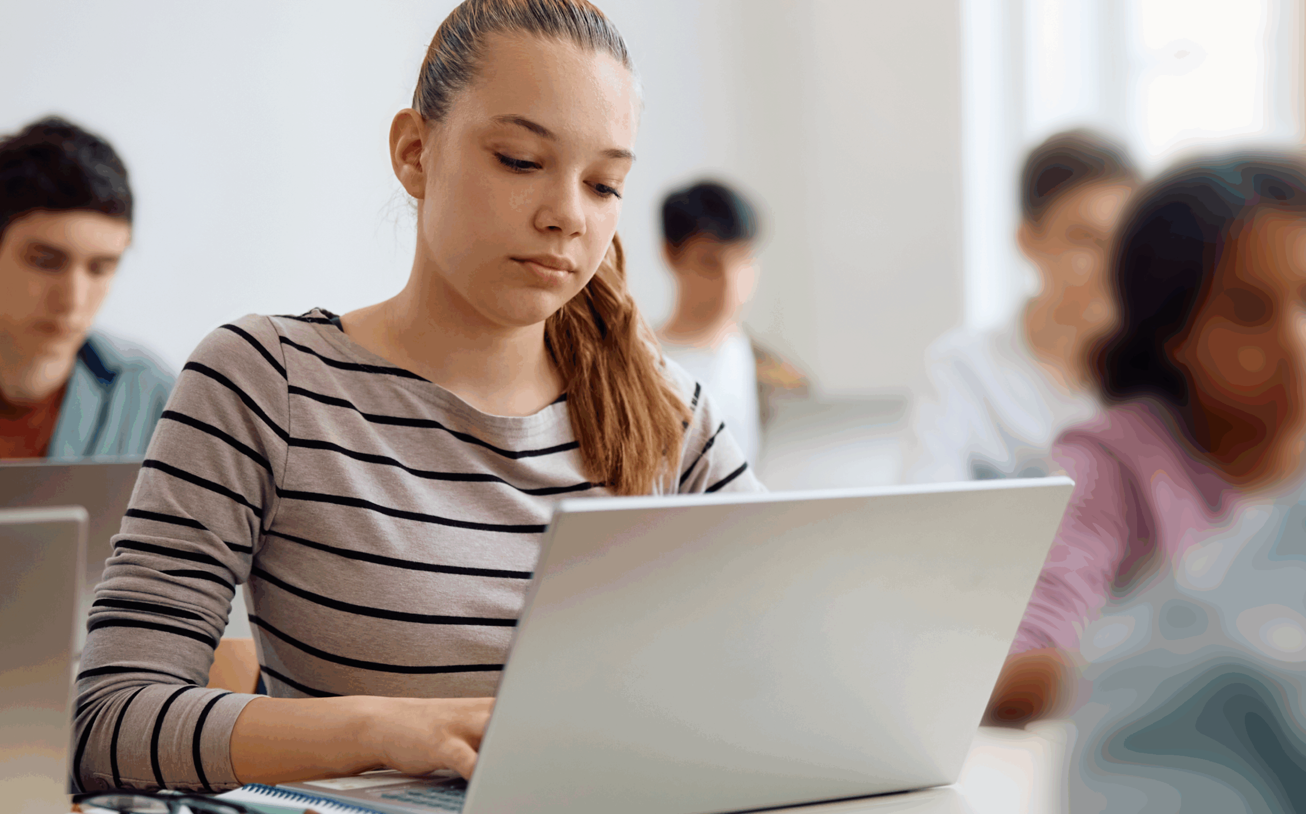 Illustration of an adult sitting at a desk and working on a laptop, with a small potted plant beside the laptop.